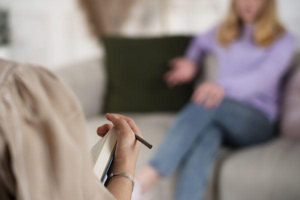 sided-view-young-girl-talking-therapist sided-view-young-girl-talking-therapist